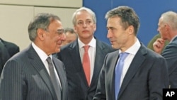US Defense Secretary Leon Panetta (L) chats with NATO Secretary General Anders Fogh Rasmussen before a North Atlantic Council meeting at a NATO Defense Ministers meeting in Brussels, February 2, 2012.