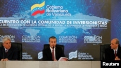 Venezuela's Vice President Tareck El Aissami, center, speaks during a meeting with bondholders and their representatives in Caracas, Nov. 13, 2017.