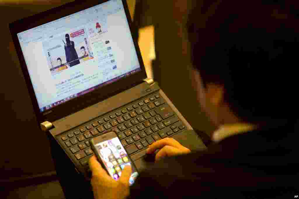 A Japanese journalist looks at a video of the hostages prior to Japan&#39;s Prime Minister Shinzo Abe press conference in Jerusalem, Jan. 20, 2015.