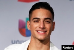 FILE - Maluma poses backstage during the 14th Latin Grammy Awards in Las Vegas, Nevada, Nov. 21, 2013.