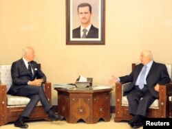 FILE - Syrian Foreign Minister Walid al-Muallem meets with U.N. mediator for Syria Staffan de Mistura in Damascus, Syria, in this handout picture provided by SANA, Nov. 20, 2016.