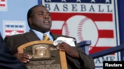 FILE - Former San Diego Padres outfielder Tony Gwynn holds his Hall of Fame plaque following his induction into the National Baseball Hall of Fame in Cooperstown, New York, July 29, 2007. 