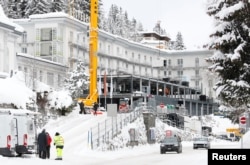 Construction workers build a temporary pavilion in front of Hotel Belvedere in Davos, Switzerland, Jan. 12, 2019.