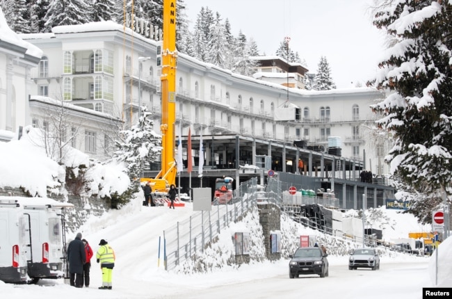 Construction workers build a temporary pavilion in front of Hotel Belvedere in Davos, Switzerland, Jan. 12, 2019.