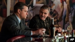 Image released by Columbia Pictures shows Matt Damon, left, and George Clooney in "The Monuments Men." 