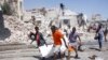 Rescuers carry away the dead body of a civilian who was killed in a blast in Mogadishu, Somalia, Jan. 12, 2022. 