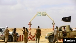 FILE - The entrance to the al-Ghani oil field, south of Ras Lanuf, Libya, formerly under rebel control, Mar. 18, 2014.