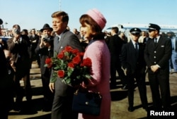 FILE - President John F. Kennedy and first lady Jacqueline Bouvier Kennedy arrive at Love Field in Dallas, Texas, Nov. 22, 1963.