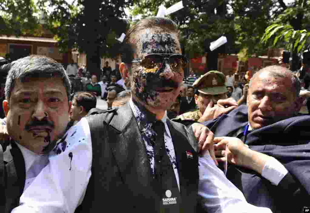 Chairman of Sahara India Pariwar Subrata Roy, with his face smeared with ink thrown by a lawyer, walks into the Supreme Court in New Delhi. The top Indian businessman faces charges of failure to return billions of dollars to investors. Roy&#39;s Sahara conglomerate is well known throughout India because it co-owns a Formula One team and sponsored the Indian cricket team until recently.