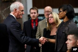 Secretary of the Navy Richard Spencer, left, shakes hands with Rachel Eckels, right, who lost her son, Navy Information Systems Technician Timothy Eckels, 23, of Manchester, Md., on the USS McCain collision, before a Senate Armed Services Committee hearing, Sept. 19, 2017, on Capitol Hill in Washington.