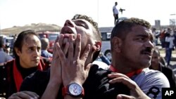 An anti-Hosni Mubarak protester reacts after hearing the verdict of the trial of the former Egyptian president outside a police academy on the outskirts of Cairo, Nov. 29, 2014.