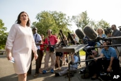 White House press secretary Sarah Huckabee Sanders takes a question from a reporter on the North Lawn outside the West Wing at the White House in Washington.