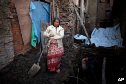 Nhuchhe Laxmi Prajapati digs the foundation of her house, which was damaged by the 2015 earthquake in Bhaktapur, Nepal, Jan. 4, 2017. Nhuchhe took out a loan of $10,000 from a local money lender and has no clue how much the interest is or how she is even how she will pay it back.