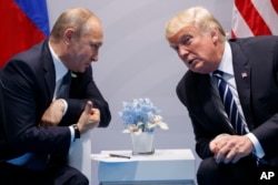 FILE - U.S. President Donald Trump meets with Russian President Vladimir Putin at the G-20 summit, July 7, 2017, in Hamburg. Trump and Putin met for more than two hours.