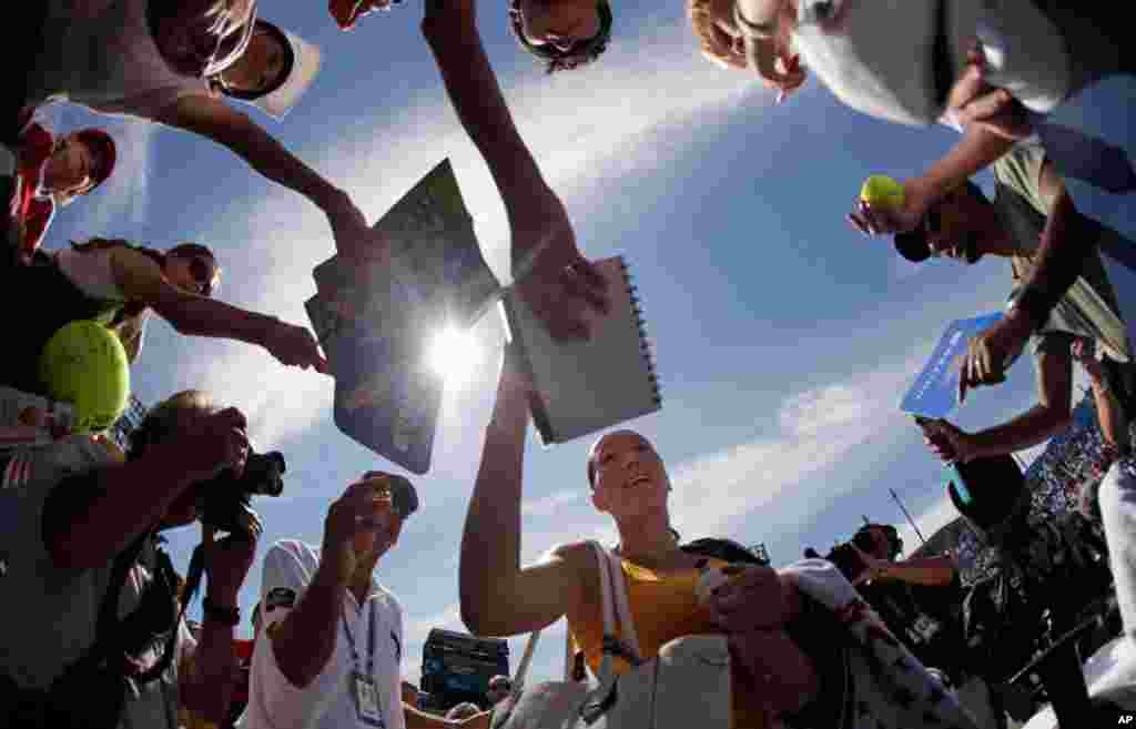 Sept. 1: Jelena Jankovic of Serbia signs autographs after her match against Jelena Dokic of Australia during the U.S. Open in New York. (AP Photo/Charlie Riedel)