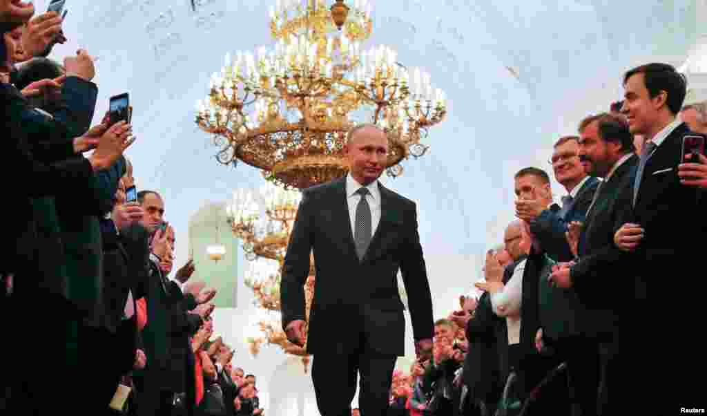 Russian President Vladimir Putin walks before an inauguration ceremony at the Kremlin. Putin was sworn in to a fourth term, extending his 18-year rule amid promises of continuity in foreign policy and renewed efforts toward building prosperity at home.