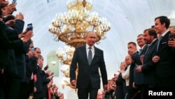 FILE - Russian President Vladimir Putin walks before his last inauguration ceremony, at the Kremlin, in Moscow, Russia, May 7, 2018.