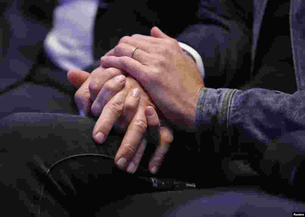 The hands of Nicolas Sarkozy, former head of the Les Republicains political party and his wife Carla Bruni-Sarkozy are seen during a political rally in Toulon, France, as he campaigns for the French conservative presidential primary.