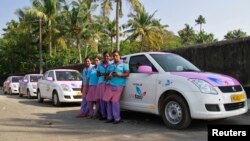 Female drivers from the 'She Taxi' service pose next to a taxi on a road in the southern Indian city of Kochi, Dec.12, 2014.