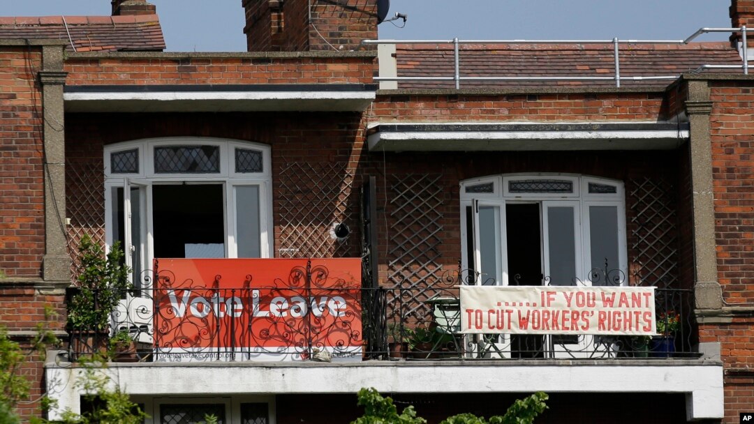 FILE - Banners of opposing views on Britain's so-called Brexit referendum on EU membership are displayed on the balconies of two neighboring apartments in the Gospel Oak area of north London, May 27, 2016.