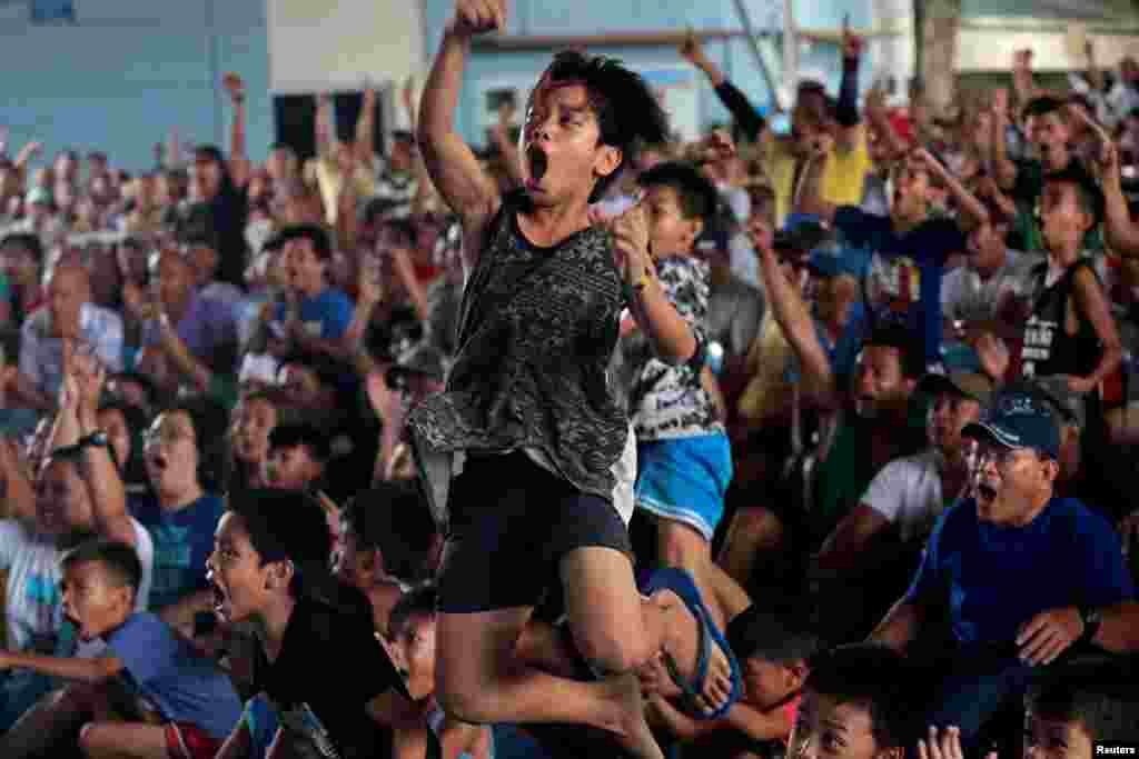 Filipino boxing fans react as they watch the WBA Welterweight match between Philippine boxing icon Manny Pacquiao and Keith Thurman of the U.S. in a live public viewing in Marikina, Philippines.