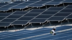 In this Aug. 8, 2019, photo a worker helps to install solar panels onto a roof at the Van Nuys Airport in the Van Nuys section of Los Angeles. On Tuesday, Oct. 8, the Labor Department reports on U.S. producer price inflation in September. (AP Photo/Richard Vogel)