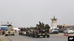 Iraqi security forces and Shi'ite militiamen prepare to attack Islamic State extremists in Tikrit, 130 kilometers (80 miles) north of Baghdad, March 13, 2015. 