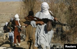 FILE - Armed Taliban fighters are seen at an undisclosed location in Nangarhar province, Afghanistan, Dec.13, 2010. Taliban fighters are currently engaged in clashes with Islamic State militants in the region.