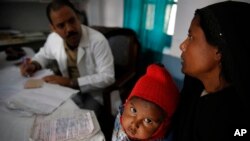 FILE - Anwar, 4, gets treated for tuberculosis at the Kashi Vidyapith block hospital near Varanasi, India, Feb. 1, 2014.