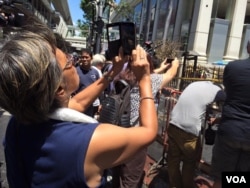 Orang mengambil 'selfie' di depan pura Erawan, lokasi pemboman di Bangkok, Thailand (18/8).(Foto: Steve Herman/VOA)