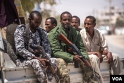 Puntland police ride on the back of a pick-up truck outside police headquarters in in Bossaso, Somalia, March 24, 2018. (J. Patinkin/VOA)