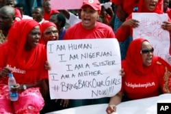 Women attend a demonstration calling on the government to rescue the kidnapped school girls of a government secondary school Chibok, outside the defense headquarters in Abuja, May 6, 2014.