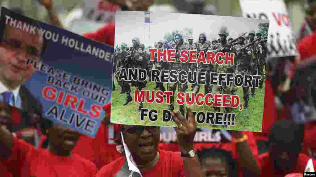 People hold placards calling for the release of secondary school girls abducted in the remote village of Chibok, during a protest along a road in Lagos, May 14, 2014. 