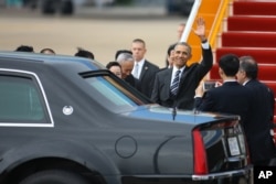 U.S. President Barack Obama waves upon his arrival at the Tan Son Nhat International Airport in Ho Chi Minh City, Vietnam during his three-day visit to the country.