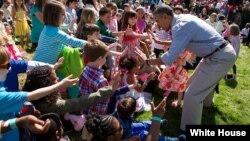 President Barack Obama greets children on the White House lawn for the annual Easter Egg roll, April 6, 2015. 
