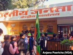 Bharatiya Janata Party supporters lined up outside the BJP office in New Delhi as election results put the party on course to win elections in Prime Minister Narendra Modi's home state of Gujarat.