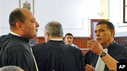 Former Tunisian President Zine El Abidine Ben Ali's lawyers Hosni Beji (L) and Abdsatar Messaoudi talk as the second trial of Tunisia's former president opened in Tunis, July 4, 2011