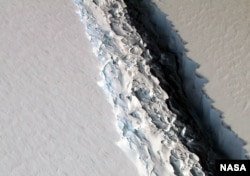This Nov. 10, 2016 aerial photo released by NASA, shows a rift in the Antarctic Peninsula's Larsen C ice shelf. According to NASA, IceBridge scientists measured the Larsen C fracture to be about 70 miles long, more than 300 feet wide and about a third of a mile deep.