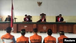 Five men, part of a gang of 14 men and boys, convicted for the rape and murder of a 14-year-old school girl, sit before judges during sentencing in Curup, near Bengkulu, on the island of Sumatra, Indonesia, Sept. 29, 2016.