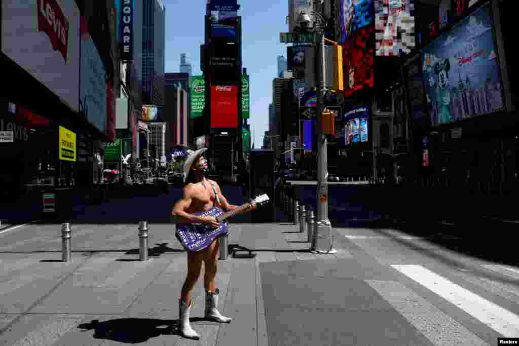 The Naked Cowboy stands alone in Times Square as Broadway theaters extended their closure due the outbreak of the coronavirus disease, in Manhattan, New York City, New York.