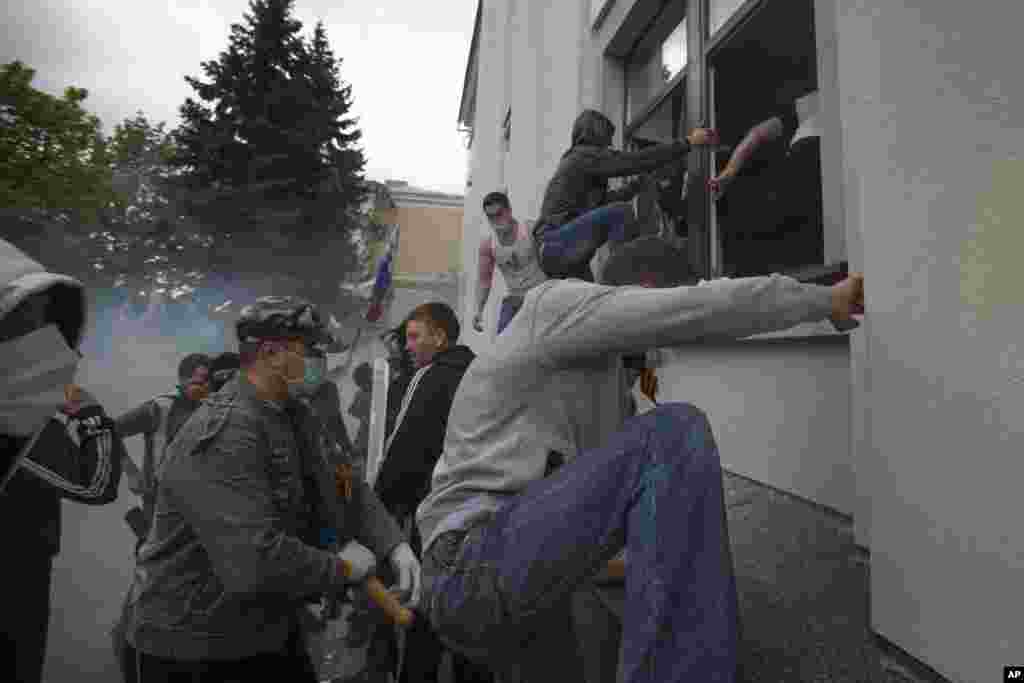 Pro-Russian activists storm an administration building in the center of Luhansk, Ukraine, further raising tensions in the east, where insurgents have seized control of police stations and other government buildings in at least 10 cities and towns.