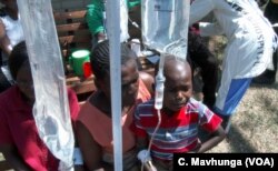 A patient receiving treatment at a temporary structure in Harare, Zimbabwe, Sept. 11, 2018, meant for waterborne diseases such as salmonella, typhoid and cholera which have hit Zimbabwe’s capital city.