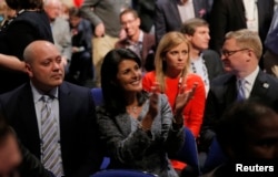 South Carolina Governor Nikki Haley applauds next to her husband, Michael, left, as she sits in the audience at the Fox Business Network Republican presidential candidates debate in North Charleston, South Carolina, Jan. 14, 2016.