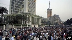 Hundreds of Egyptian Christians march in front of Egyptian Foreign Ministry building, left, and Television building tower, in Cairo, Egypt, Jan 2, 2011