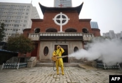 A worker disinfects the Hankou Salvation Church in Wuhan, in China's central Hubei province on March 6, 2020.