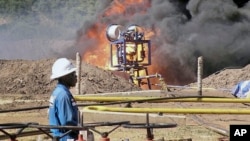 FILE - An oil well undergoes testing in the Lake Albertine region of western Uganda.