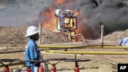 FILE- An oil well undergoes testing in the Lake Albertine region of western Uganda.