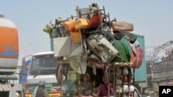 FILE - Afghan refugees who fled their country due to war return to Afghanistan at the Chaman border in Pakistan, Sept. 9, 2016.