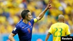 Robin van Persie of the Netherlands celebrates after scoring a goal from a penalty kick during their 2014 World Cup third-place playoff against Brazil, Brasilia national stadium, July 12, 2014.