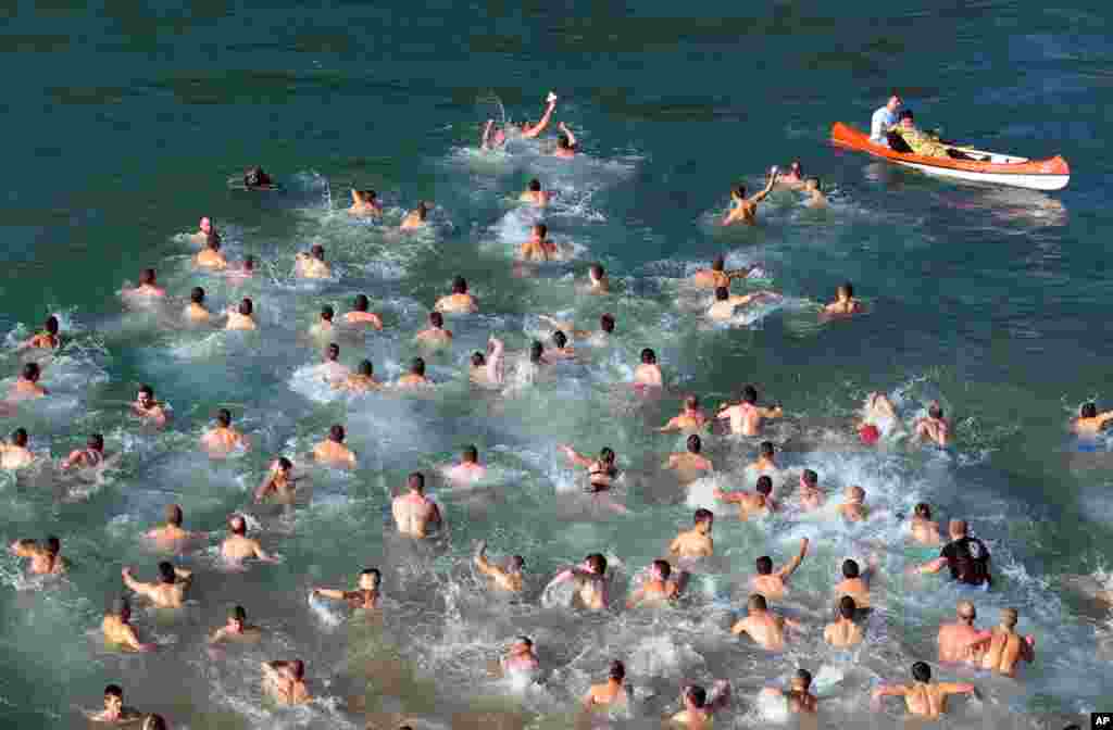 Christian Orthodox believers swim across cold water for a cross in the river Ribnica, in Podgorica, Montenegro, marking Orthodox Epiphany.